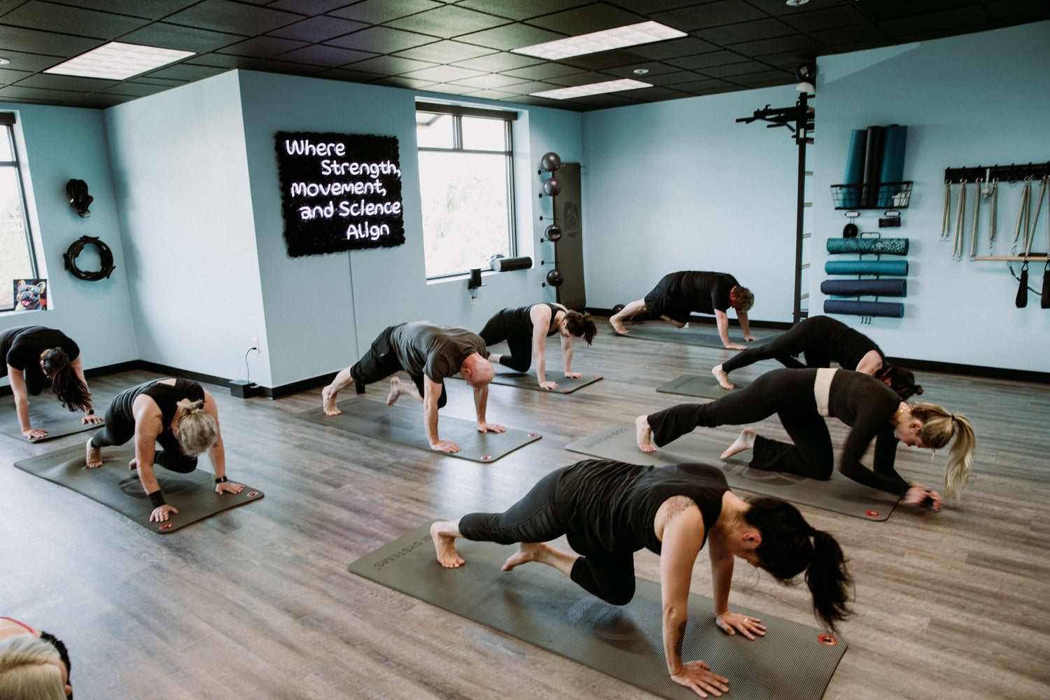 A group doing a Mat Pilates fitness class