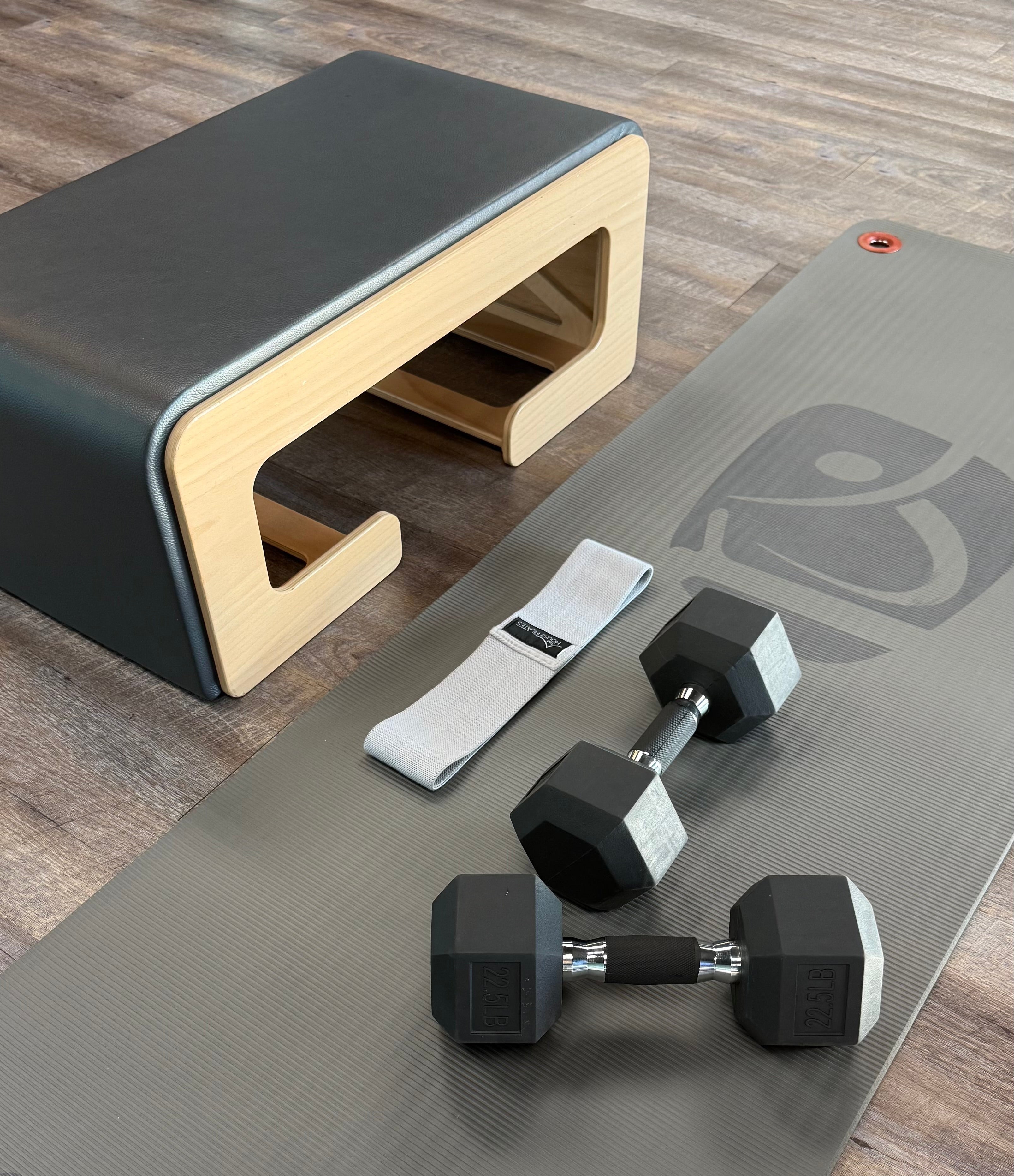 A bench, dumbbells and a fabric resistance band for a good time.