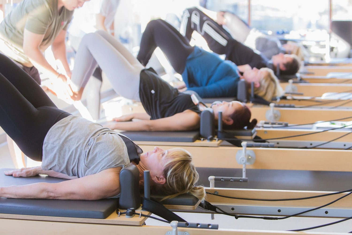 people on pilates reformers
